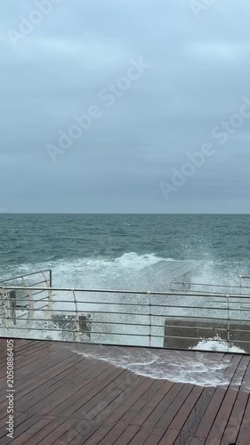 Powerful Storm Waves Crashing Against Wooden Boardwalk In Odessa