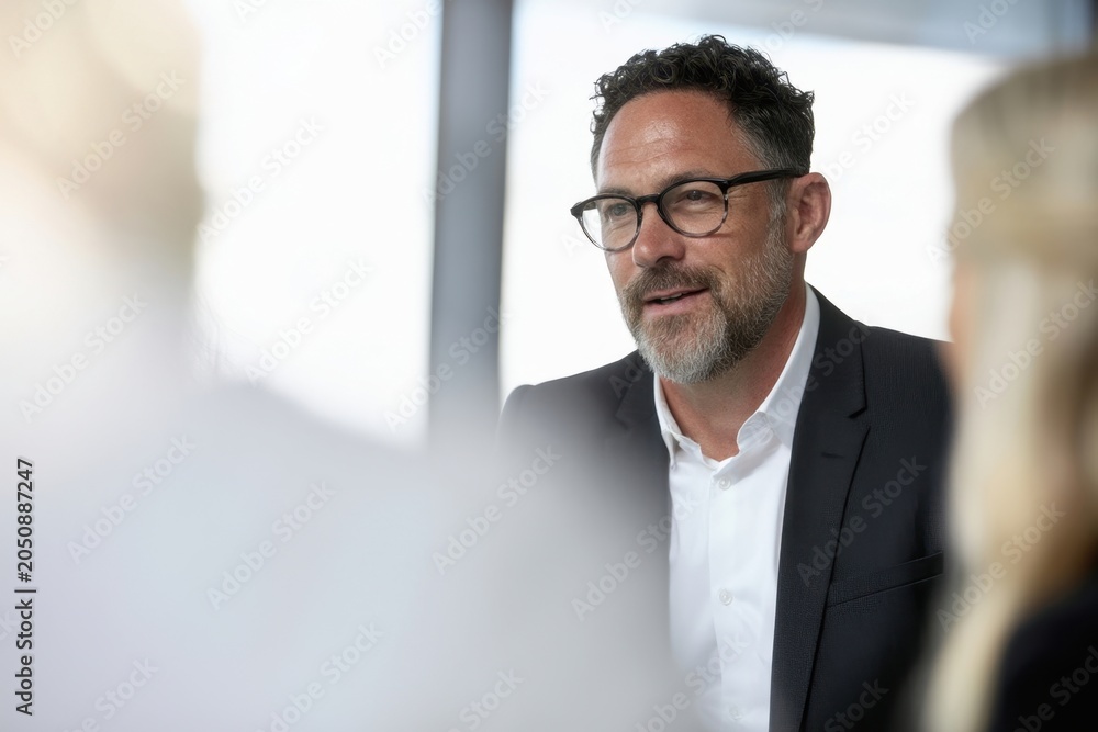 Fototapeta premium The businessman leading a confident corporate meeting with colleagues in a modern office