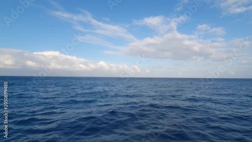 various shapes of clouds in the sky above the choppy sea