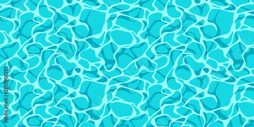 The vibrant turquoise water surface reflects sunlight creating a mesmerizing pattern of light and shadow on a sunny day outdoors.