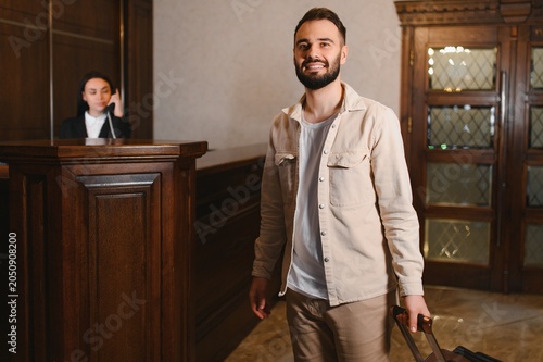 Slika na platnu Guest arriving at hotel lobby for check in