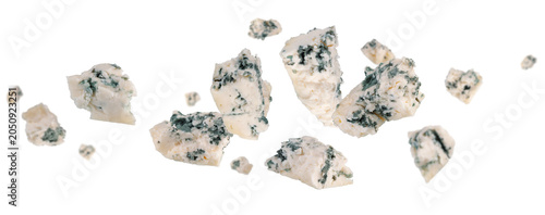 Abstractly chopped pieces of blue cheese fly and levitate in space. Isolated on white.