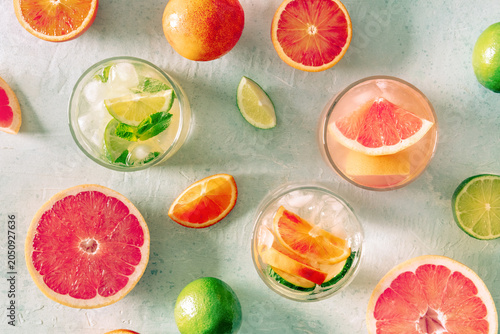 Refreshing summer cocktails with ice cubes on a light background