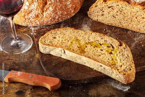 Homemade artisan sourdough bread loaf on a rustic wooden cutting board
