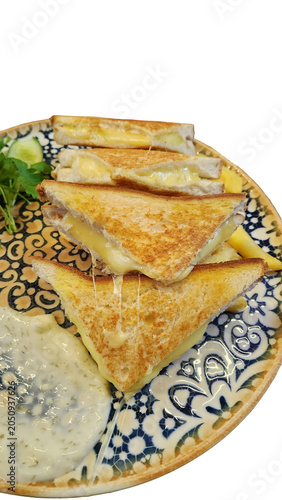 Slices of cheese toast served with sauce on a plate.
