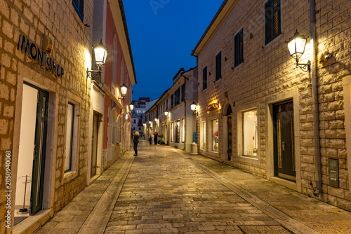 Atmospheric evening street illuminated by lanterns in the old town of Herceg Novi