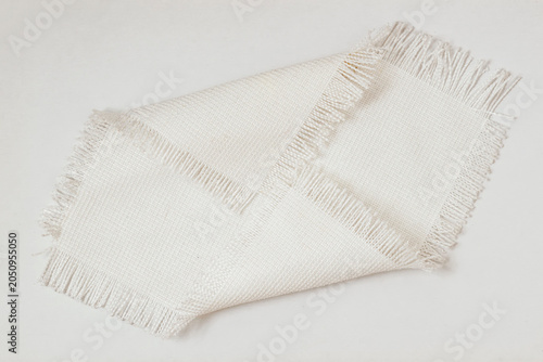 Fabric texture sample with woven threads and fringe edges placed on surface, textile sample, neutral modern tone, detailed weave pattern for design. Natural background, fabric texture