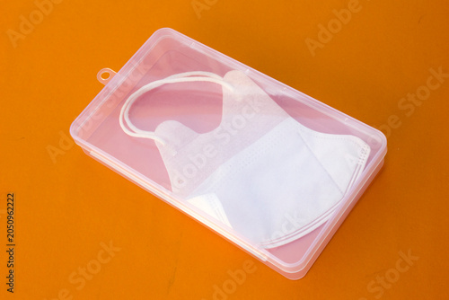 Tablou pe pânză A white mask inside a clear plastic box