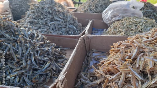 Variations of drysalted anchovies fish or ikan teri in Indonesian language on seller's stall at the rural traditional market