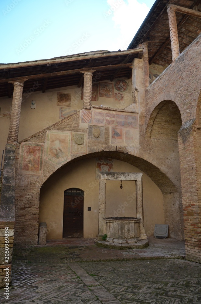 Naklejka premium San Gimignano, Italy 03.04.2020: View of the inner courtyard of the Palazzo Nuovo del Podestà