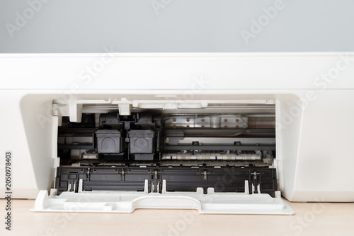Close-Up Interior View Of A Home Printer With Open Tray Showing Ink Cartridges And Feed Mechanism