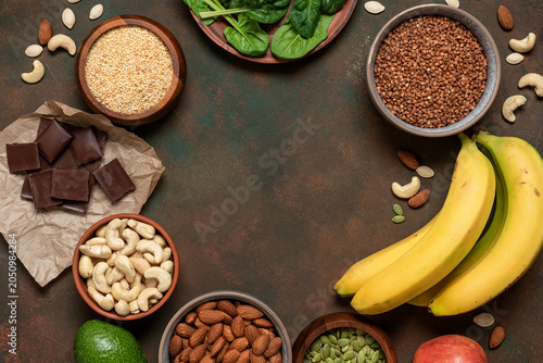 Frame of various high magnesium foods on dark grunge background, top view, flat lay, copy space.