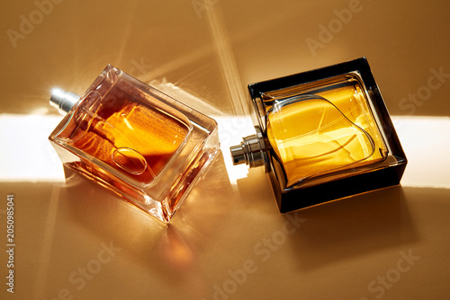 Принти на полотні Luxury gourmand perfume bottles reflecting elegant warm light