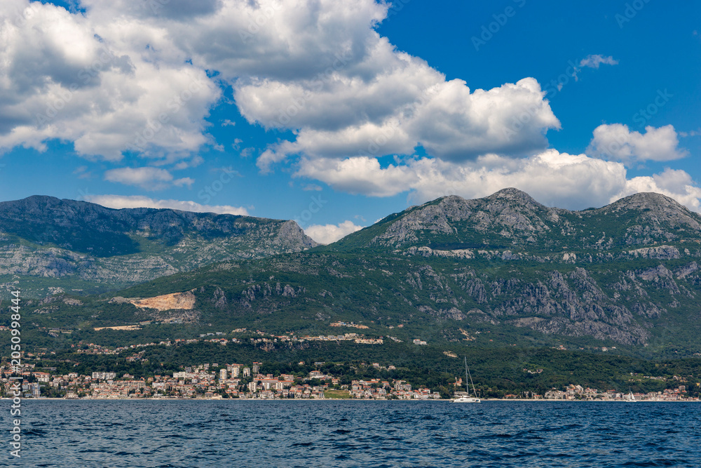 Fototapeta premium Rugged stone cliffs and pristine turquoise waters along the scenic Adriatic coastline near Herceg Novi