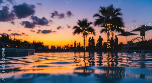 Tropical summer vacation sunset poolside gathering with string lights and palm trees