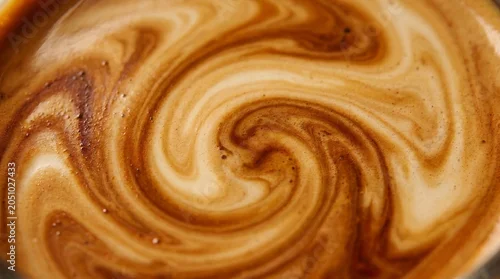 Fototapeta na wymiar The coffee and milk were stirred together until they blended to create a pattern