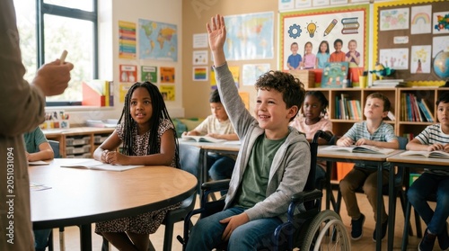 Smiling boy in a wheelchair raising his hand in a classroom, actively participating in a lesson. Inclusive education concept highlighting accessibility, student engagement, disability awareness.