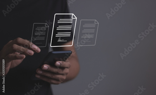 Young man uses a smartphone to sign a business contract online, Oline business contract, Electronic signature, Digital documents, Future business contract signing