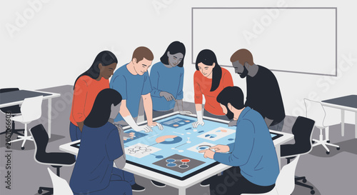 Diverse group of young professionals collaborating around a digital interactive touch screen table in a modern office.