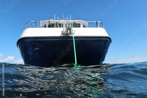 Obraz na płótnie Dive Boat on the Baltic Sea Viewed from Water Level Under Clear Coastal Sky