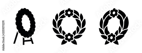 Obraz na płótnie Set of three black silhouette wreath icons on white background.