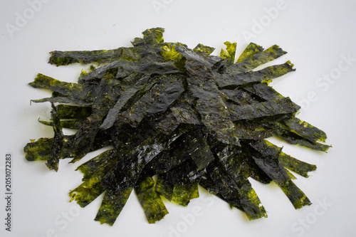 Large Pile of Julienne Cut Crispy Roasted Nori Seaweed on White Background