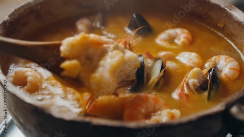 Ultra realistic cinematic footage of Brazilian seafood moqueca, coconut broth bubbling, no people, 4K UHD