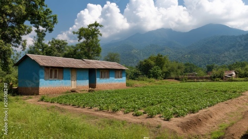 Rural Schoolhouse with Lush Fields and Mountain Backdrop