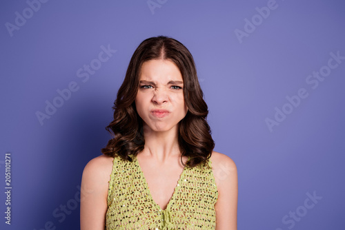Canvastavla Young woman making a disgusted face against a purple background, grimacing in an