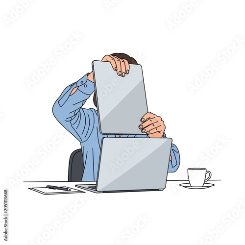 Frustrated man sitting at desk with laptop.