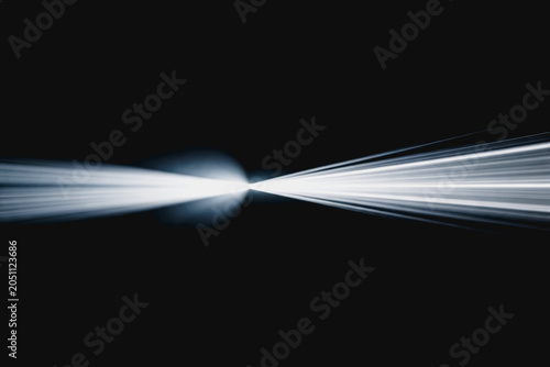 Bright white light beams spread across a dark black background, showing clear contrast and sharp optical lines.