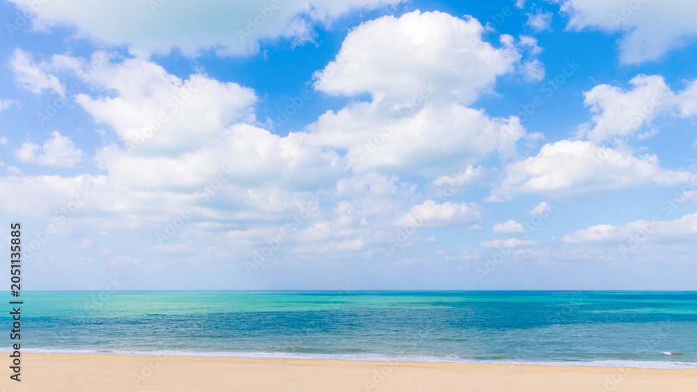 Fototapeta premium Beautiful tropical beach background with golden sand, turquoise sea water and white clouds on blue sky. Ajman, UAE