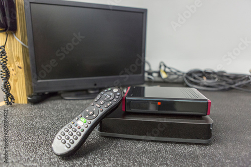 Close-up of cable modem, set top box and TV