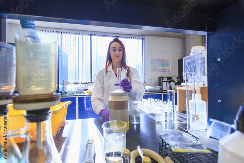 Lab chemist preparing graduated cylinder for standard solution