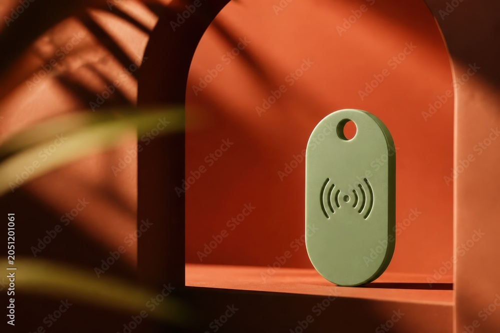 Obraz premium Green NFC tag on orange arch background with soft shadows