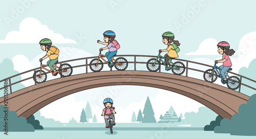 Group of young children wearing safety helmets riding their bicycles across a curved stone bridge in a peaceful green park.