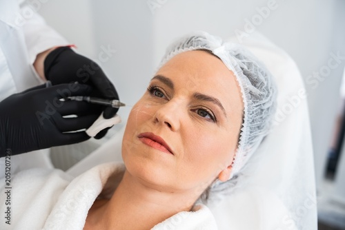 Cosmetic treatment process in a modern beauty clinic environment