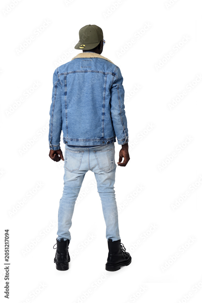 Fototapeta premium Portrait of a young man in street clothes from behind on a white background.
