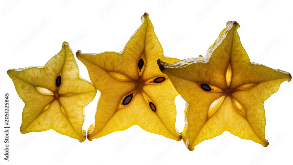 Naklejka premium Three backlit star fruit slices with visible seeds