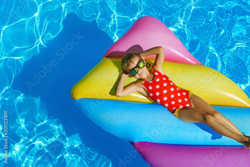 Child in swimming pool. Having fun on vacation at the hotel pool. Colorful vacation concept.