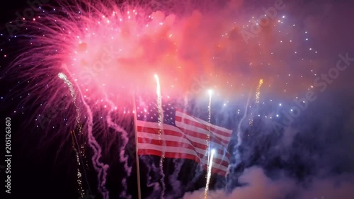 American Flag Waves Amidst Dazzling Fireworks Display
