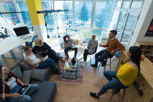 High Angle View Of Diverse Business Team Collaborating In Modern Creative Hub