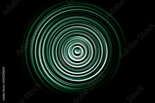 Abstract radial motion blur in neon green and dark tones, forming glowing concentric rings with a hypnotic wave‑like energy effect.