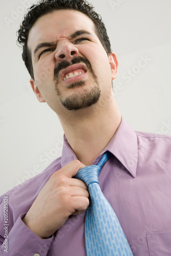 Close-up of a businessman loosening his tie