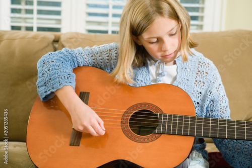 View of a cute girl playing a guitar