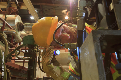 Engineer in electric power plant inspecting a electrically controlled valve