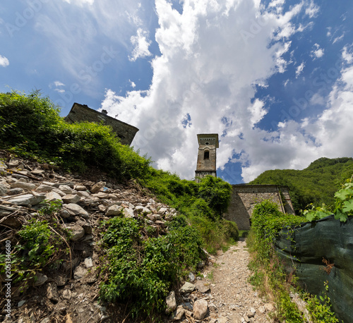 The stone facade of an ancient and beautiful house, stone roofs in the village of Isola Santa on the shore of the homonymous lake, magic in the heart of the Apuan Alps, in the province of Lucca