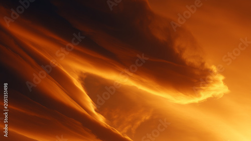 Golden hour sky with wispy clouds illuminated by the setting sun casting warm light across the scene