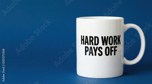 Motivational coffee mug with Hard Work Pays Off text, white ceramic cup on blue background, inspirational business quote for office productivity
