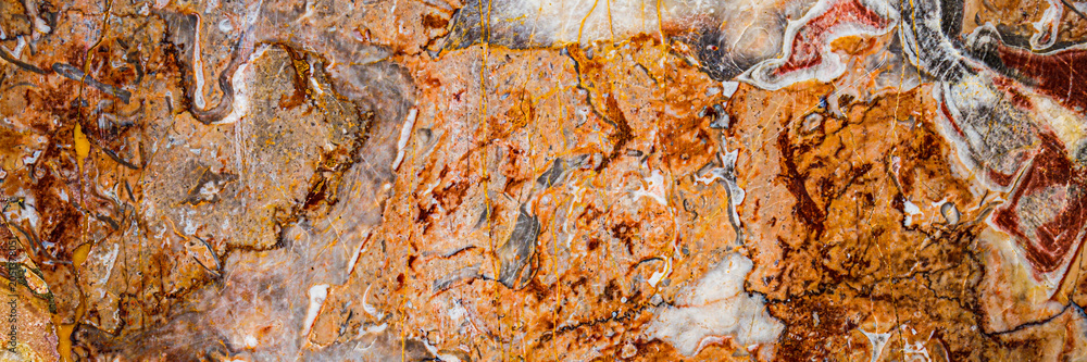 Naklejka premium Natural stone surface with patterns in shades of orange and brown found in a rock formation during the day